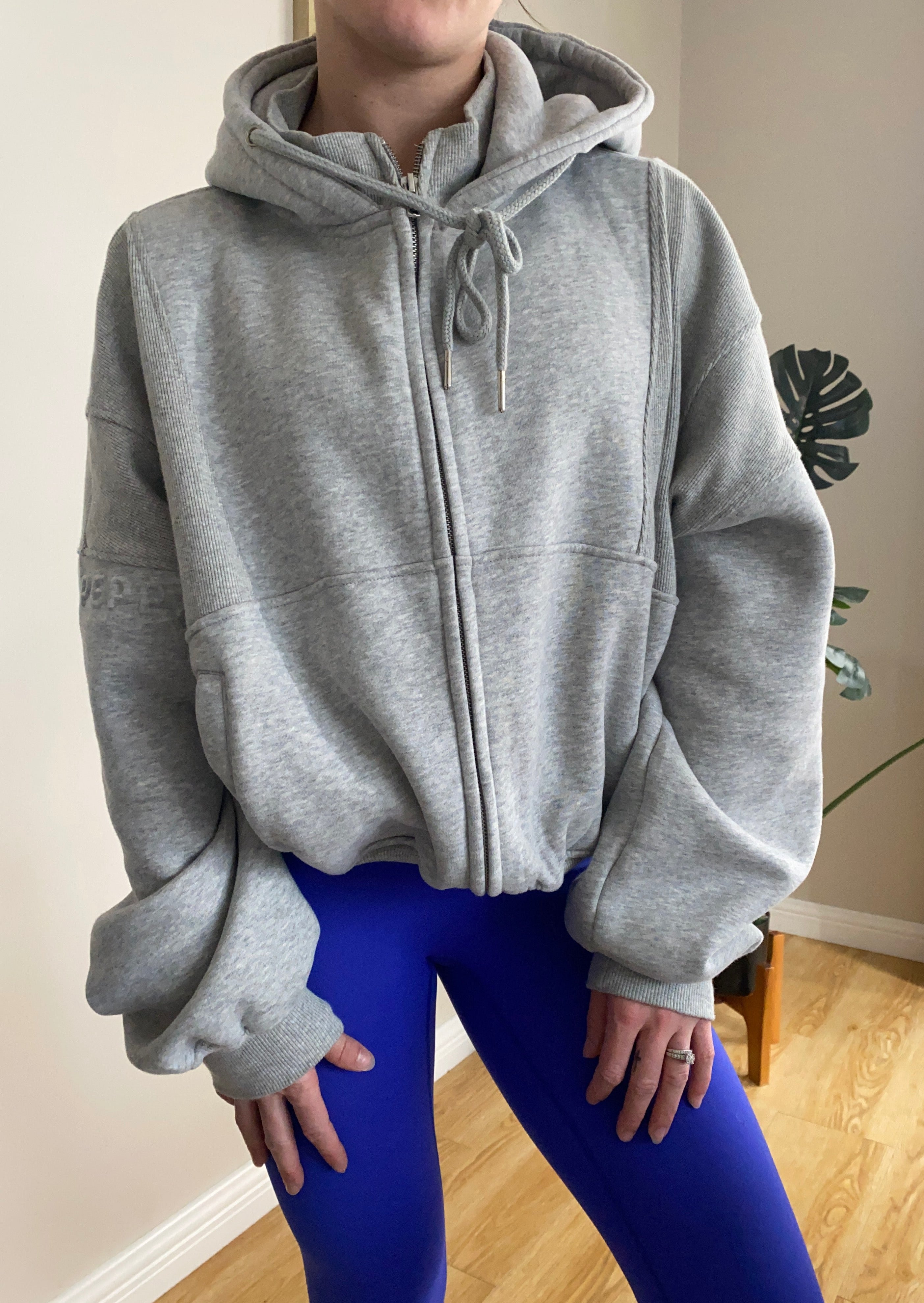 Fleece lined jacket in marl grey with full zip, hood, ribbed panels, zip pockets and embossed logo's.