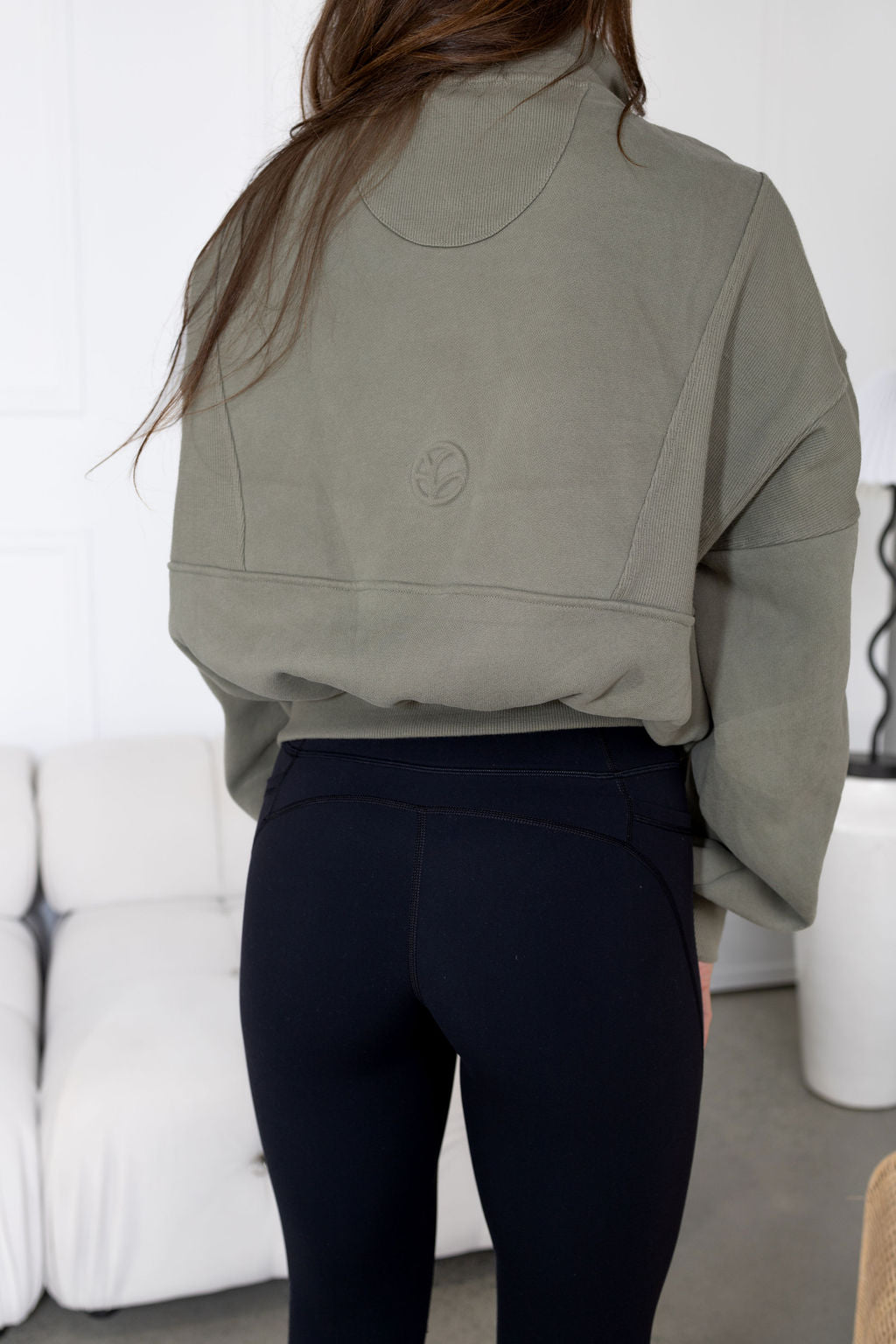 Fleece lined crop jacket in olive green with half zip, and ribbed panels, and side pockets.