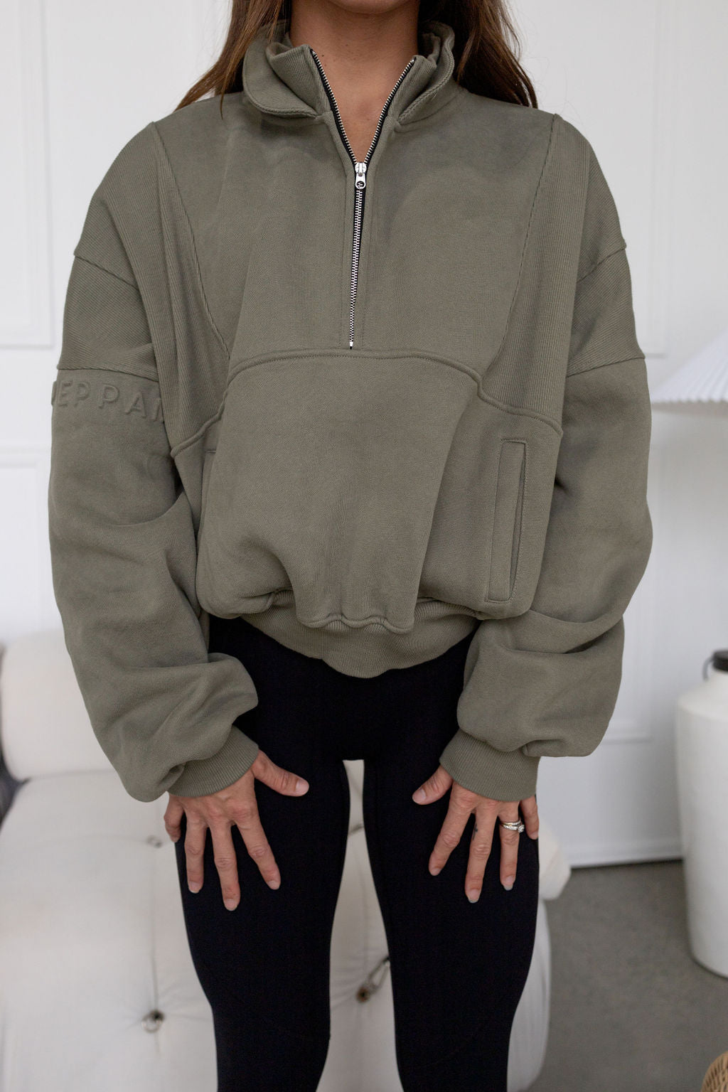 Fleece lined crop jacket in olive green with half zip, and ribbed panels, and side pockets.