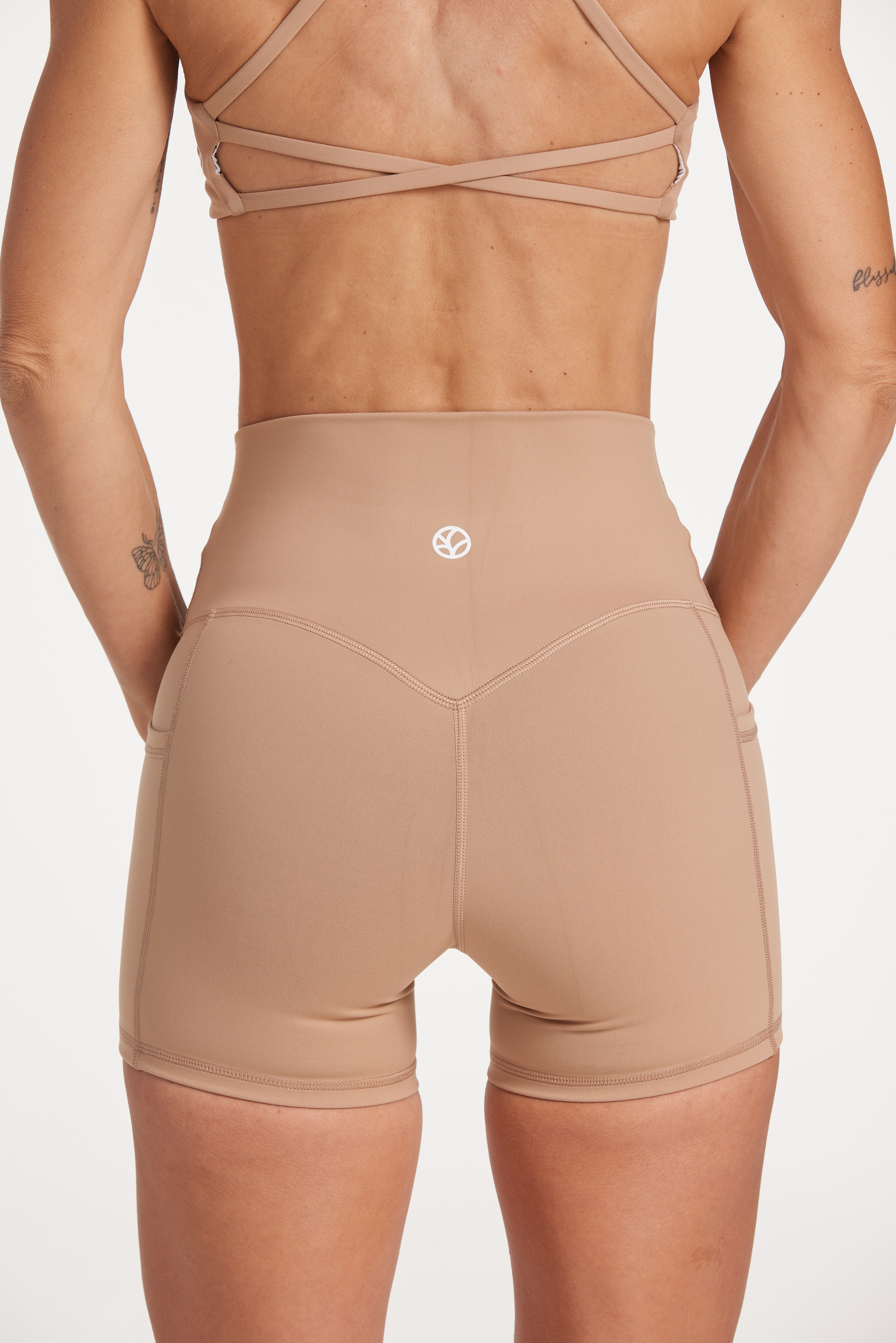 high waisted 4" inseam activewear shorts with no front rise seam, in a buttery soft, supportive fabric in light taupe colour