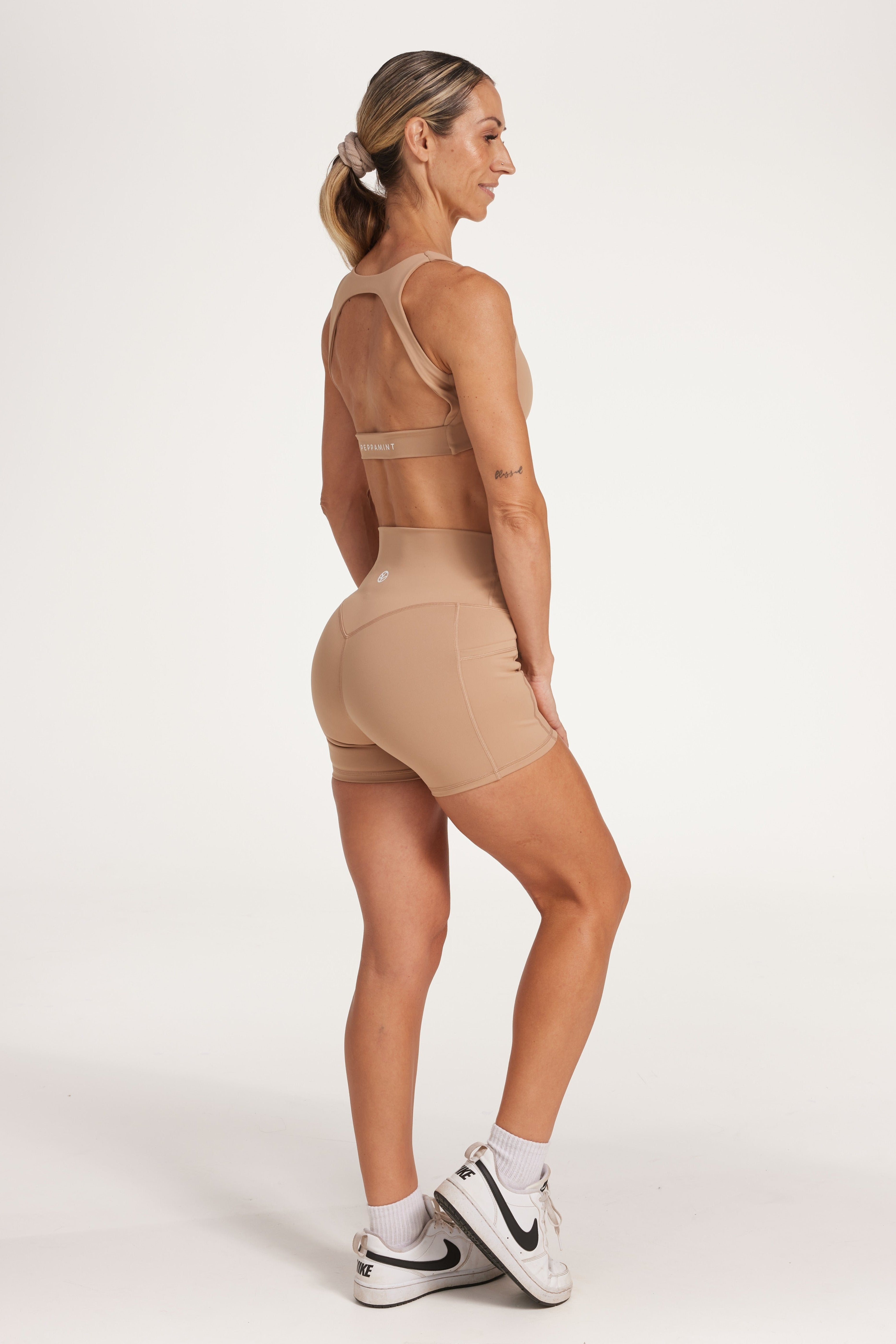high waisted 4" inseam activewear shorts with no front rise seam, in a buttery soft, supportive fabric in light taupe colour
