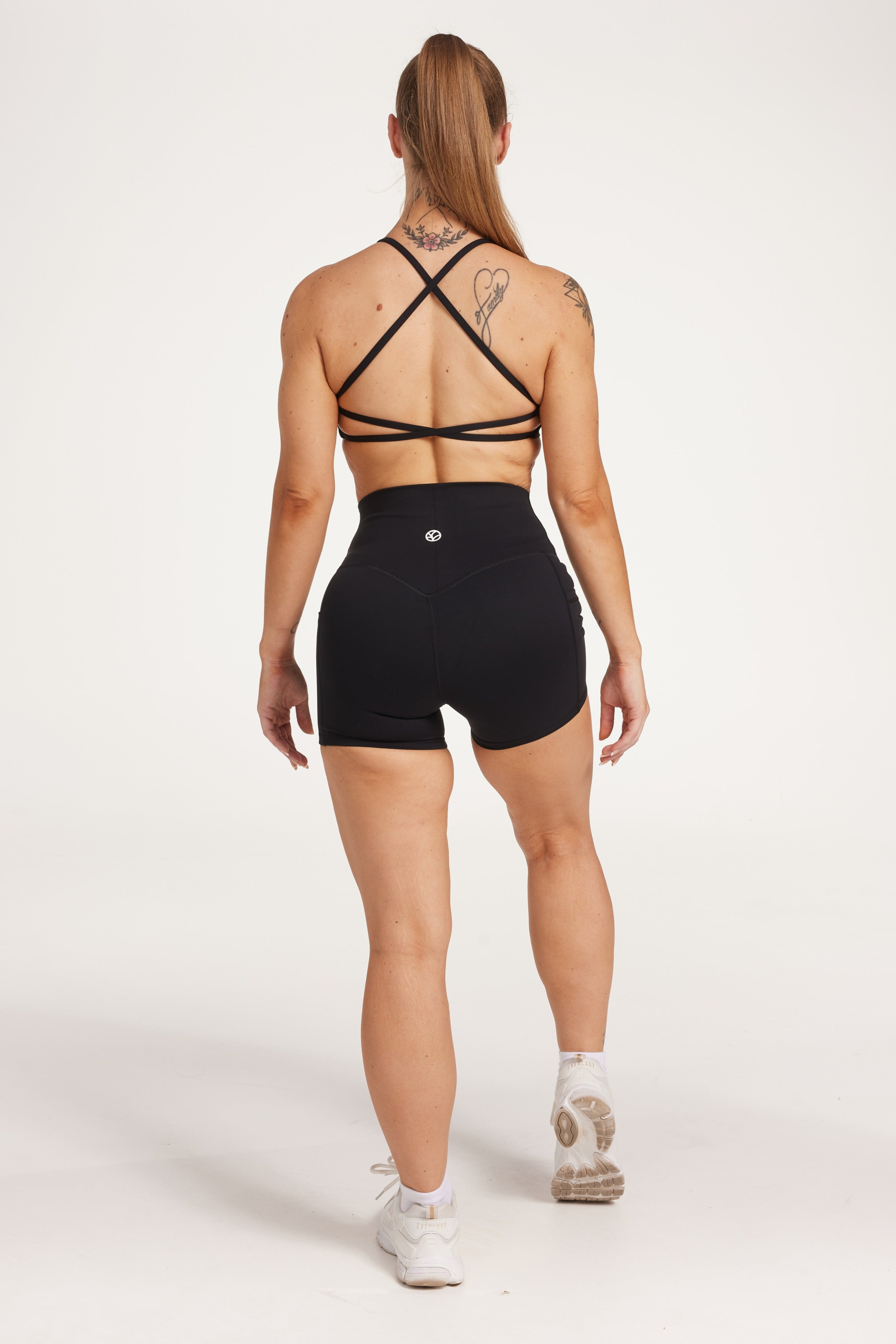 high waisted 4" inseam activewear shorts with 2 pockets, no front rise seam, in a buttery soft, supportive fabric with twist bra and cross back straps