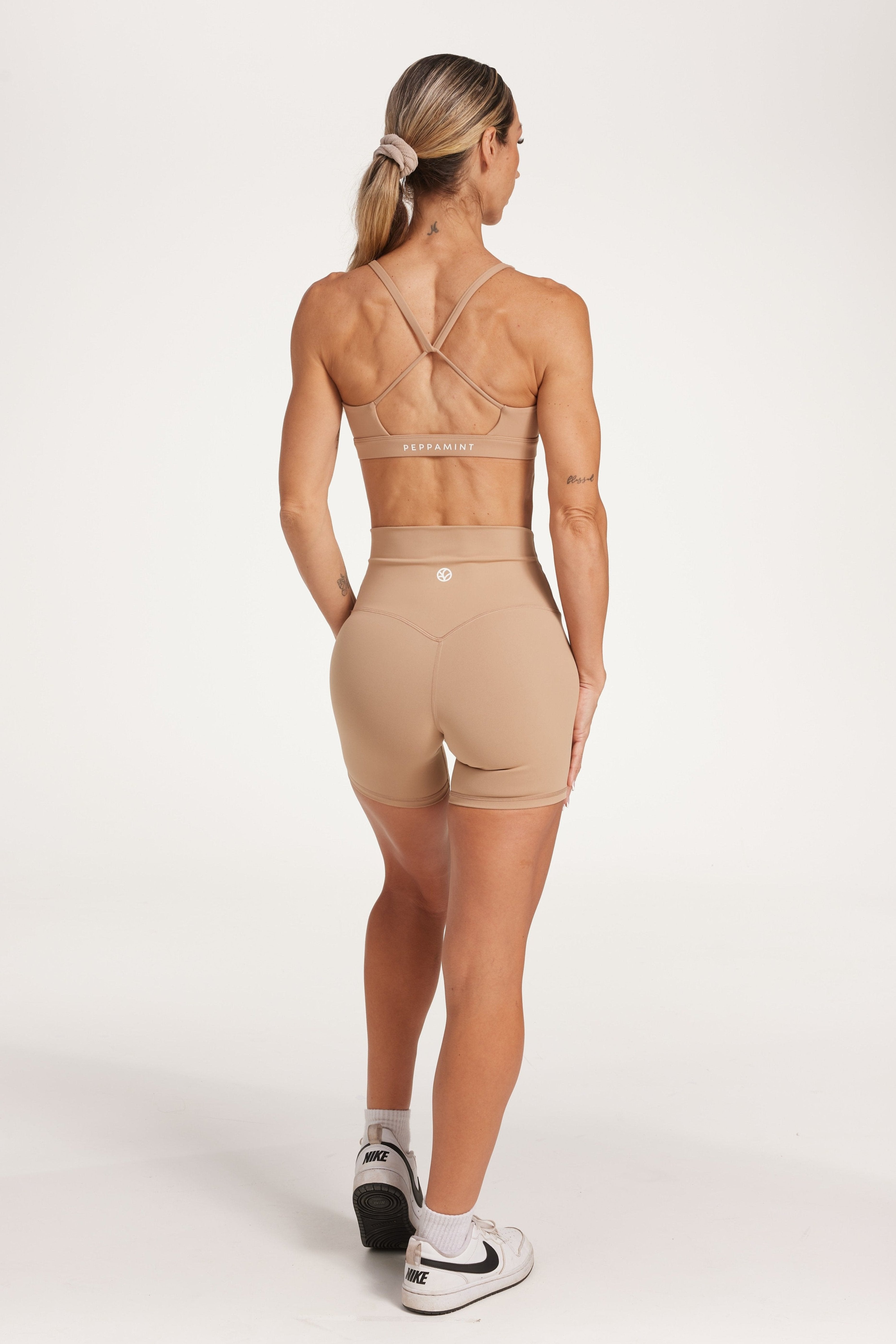 high waisted gym shorts, in buttery soft, supportive fabric with 6 inch inseam and no front rise seam, in a light taupe colour with women's moderate support activewear bra in buttery soft fabric with stunning triangle open back detail and scoop neckline 