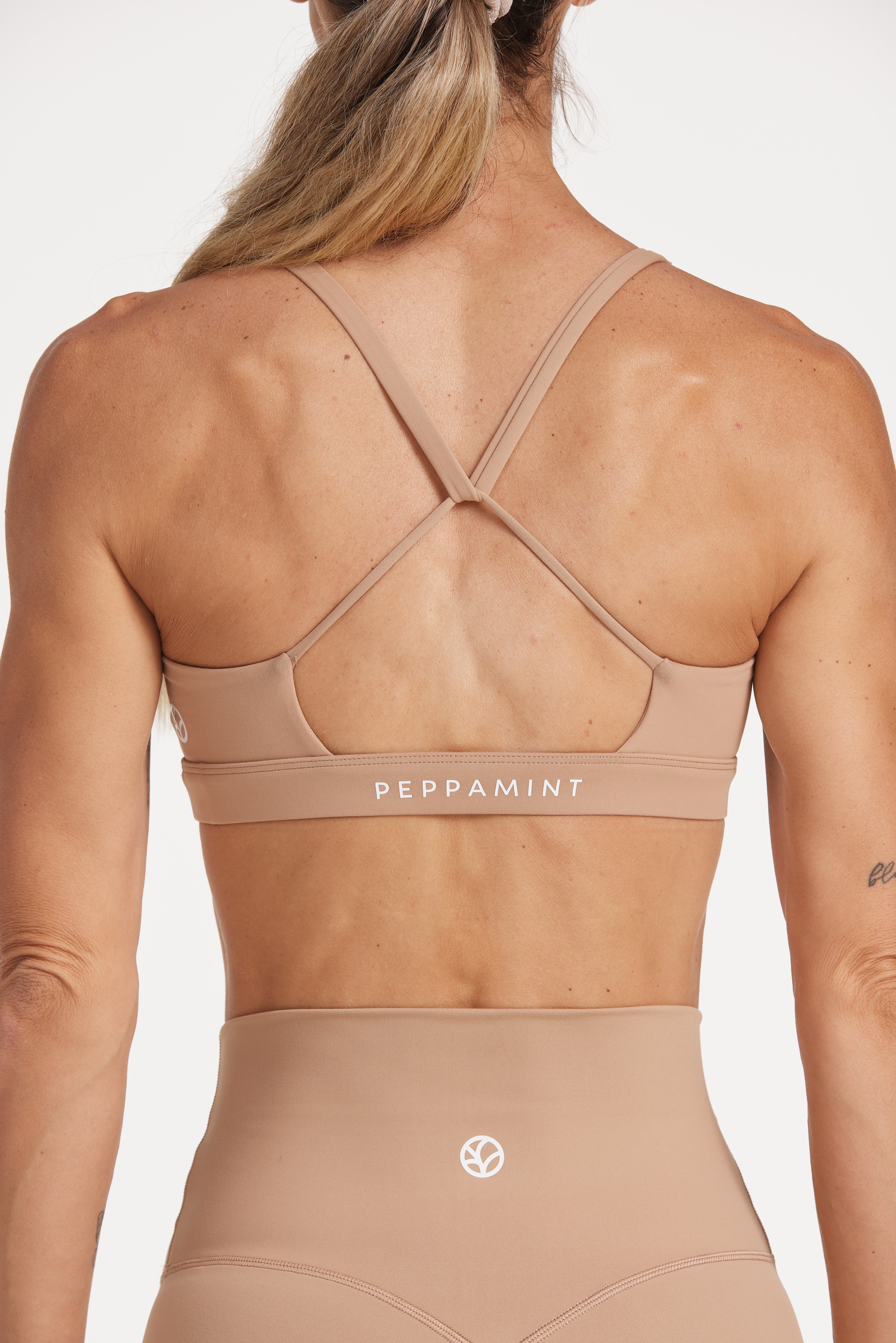 women's moderate support activewear bra in buttery soft fabric with stunning triangle open back detail and scoop neckline 