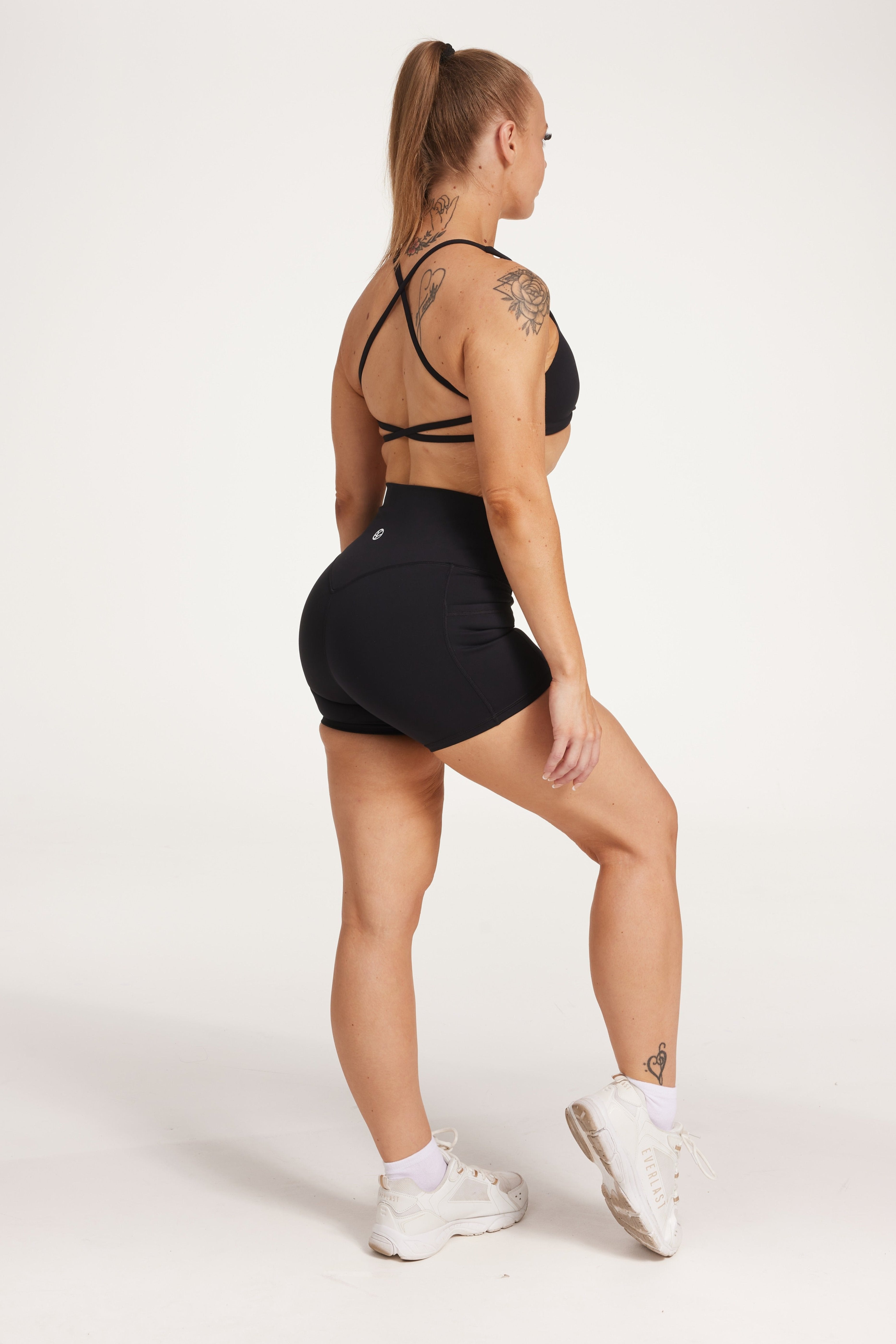 high waisted 4" inseam activewear shorts with 2 pockets, no front rise seam, in a buttery soft, supportive fabric with twist bra and cross back straps