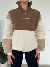 Load image into Gallery viewer, 1/4 button up fleece jumper with earthy colour panels in chocolate and beige, with feature panels ribbed stretchy fabric inserts, and two convenient zip pockets.
