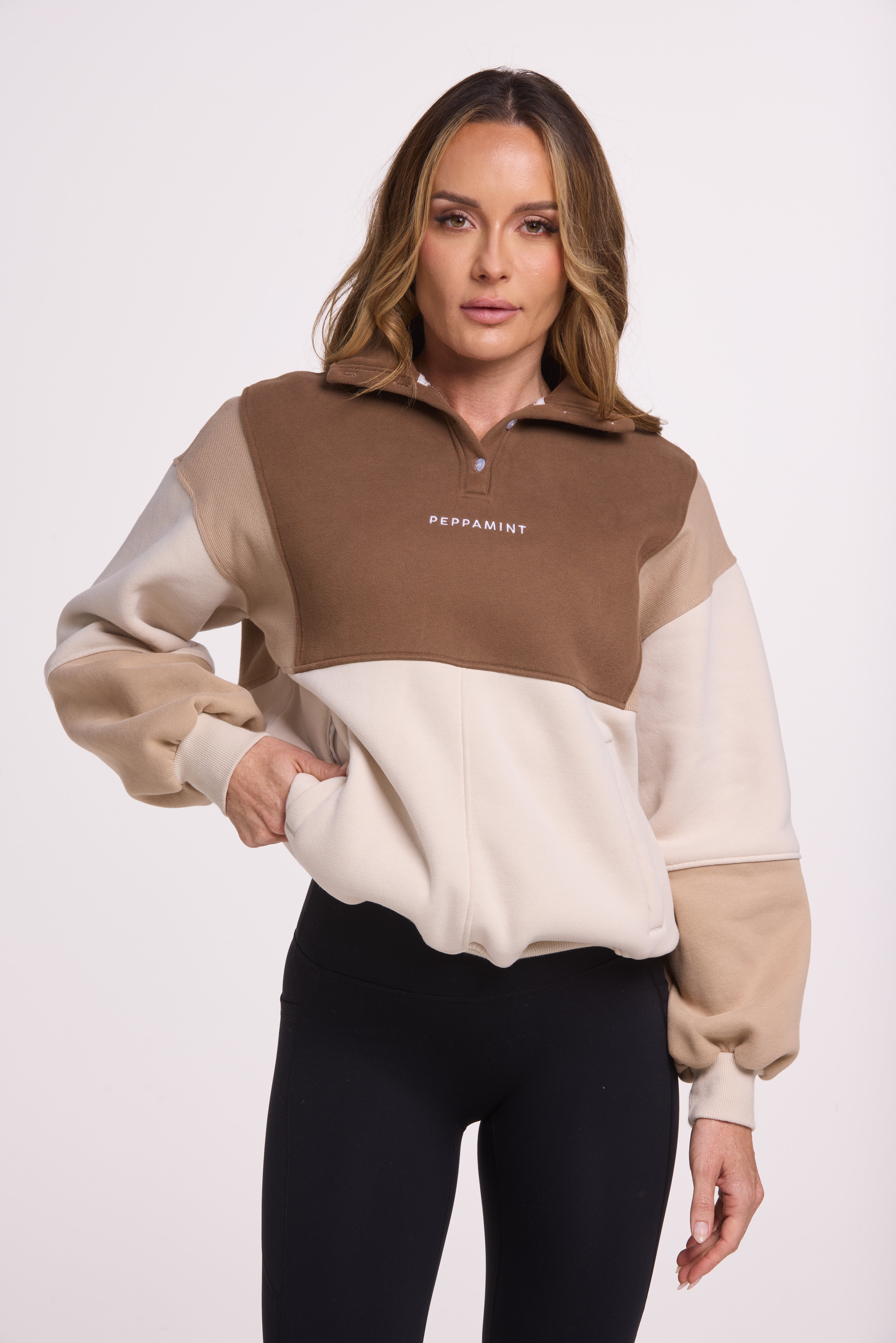1/4 button up fleece jumper with earthy colour panels in chocolate and beige, with feature panels ribbed stretchy fabric inserts, and two convenient zip pockets.
