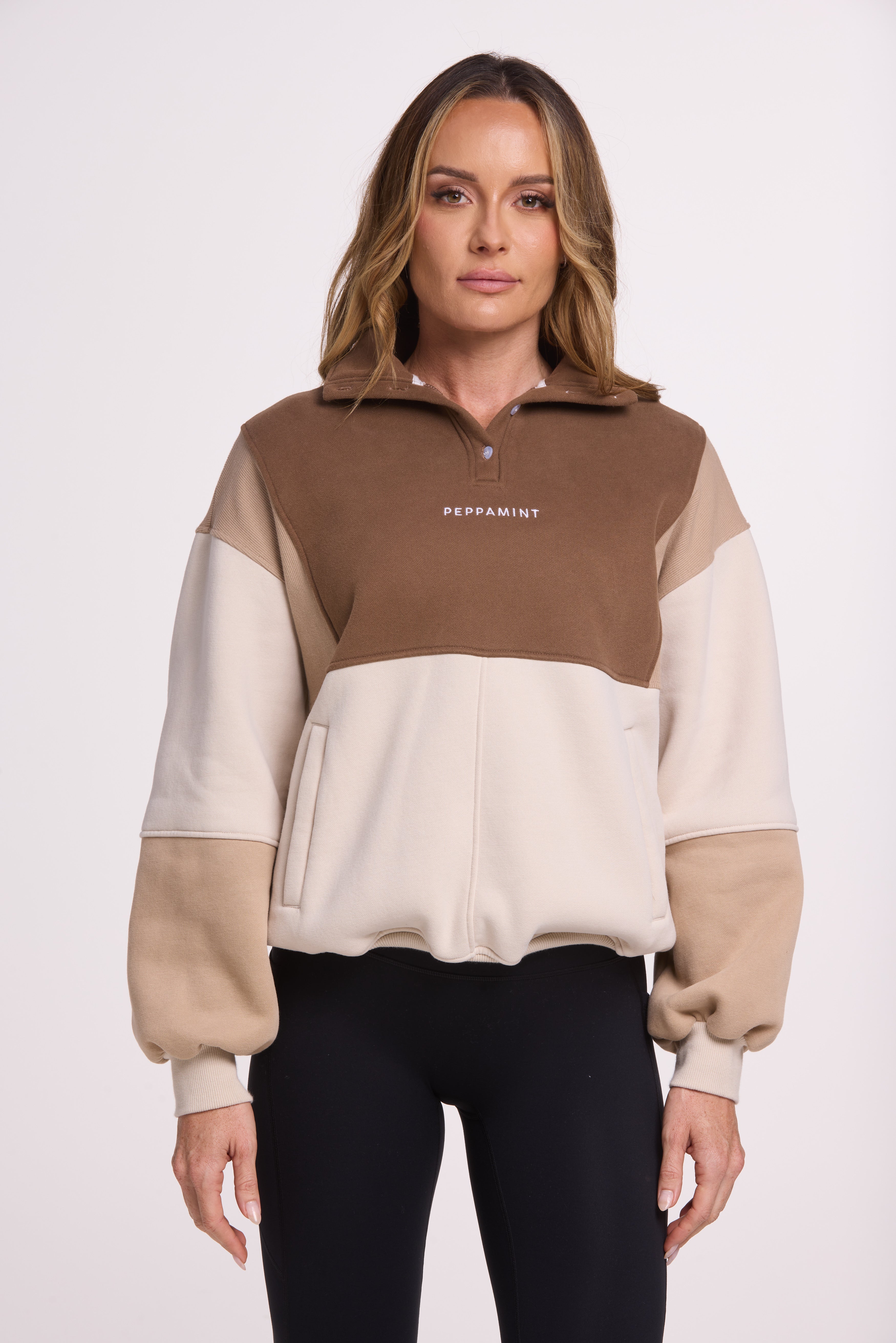 1/4 button up fleece jumper with earthy colour panels in chocolate and beige, with feature panels ribbed stretchy fabric inserts, and two convenient zip pockets.