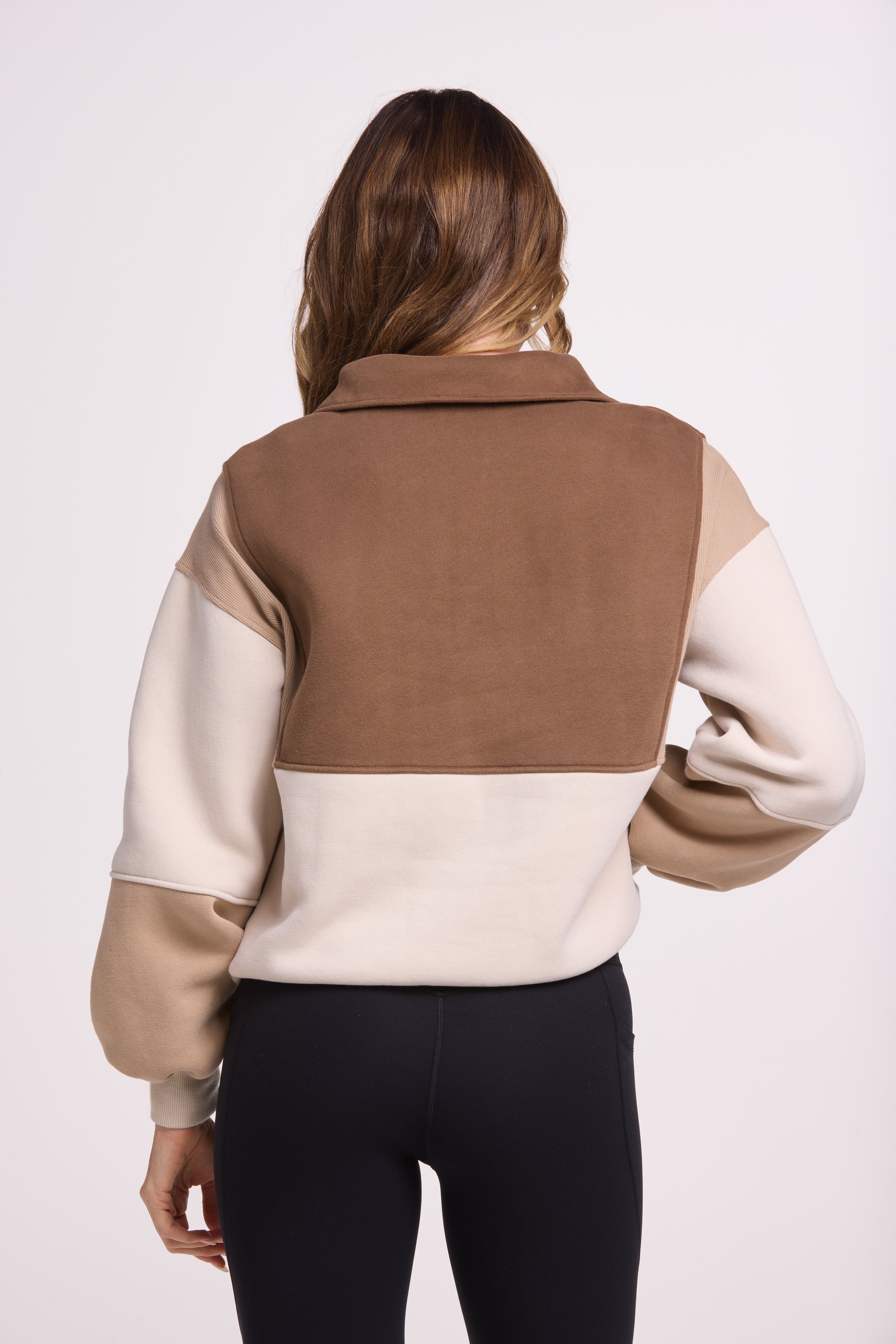 1/4 button up fleece jumper with earthy colour panels in chocolate and beige, with feature panels ribbed stretchy fabric inserts, and two convenient zip pockets.