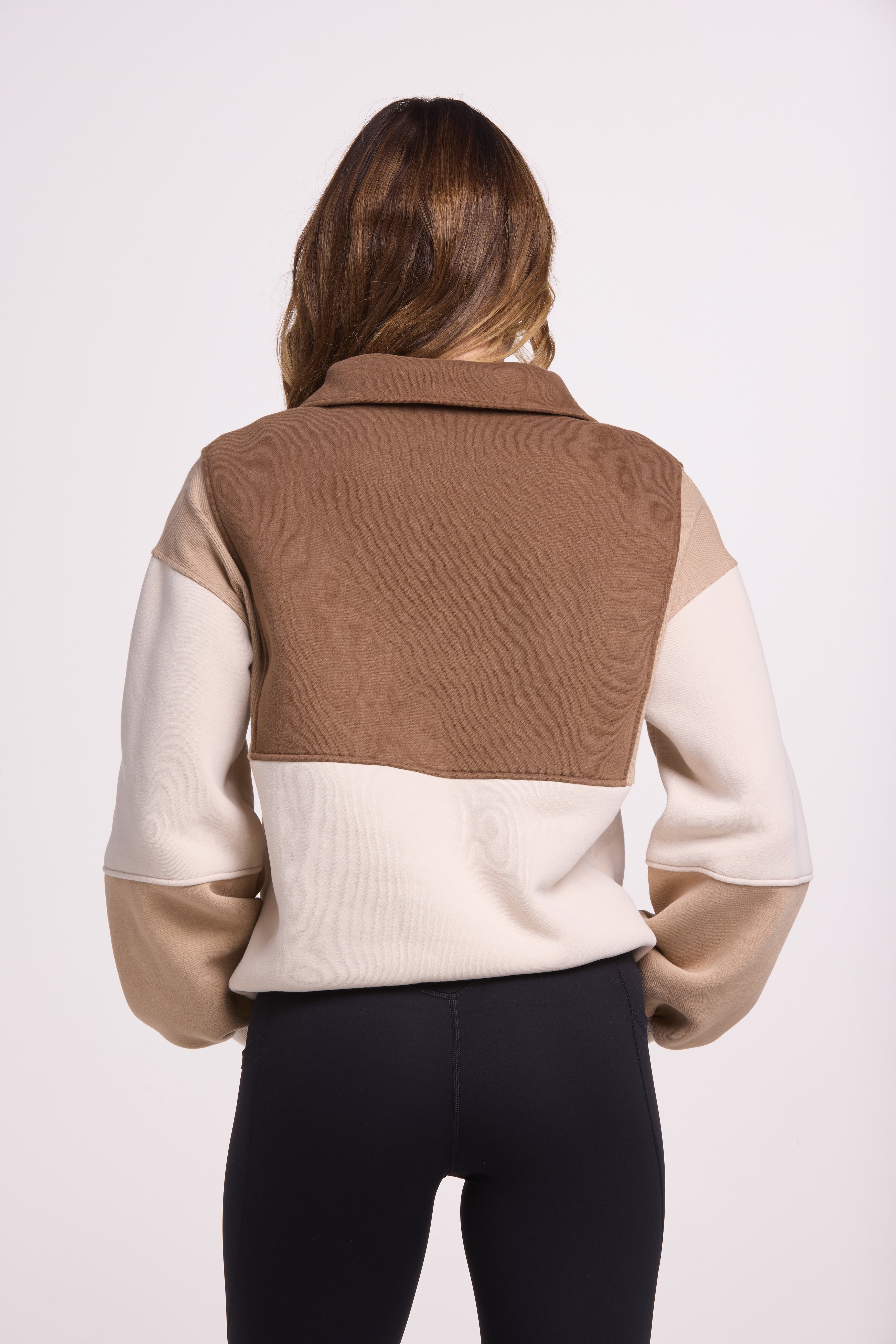 1/4 button up fleece jumper with earthy colour panels in chocolate and beige, with feature panels ribbed stretchy fabric inserts, and two convenient zip pockets.