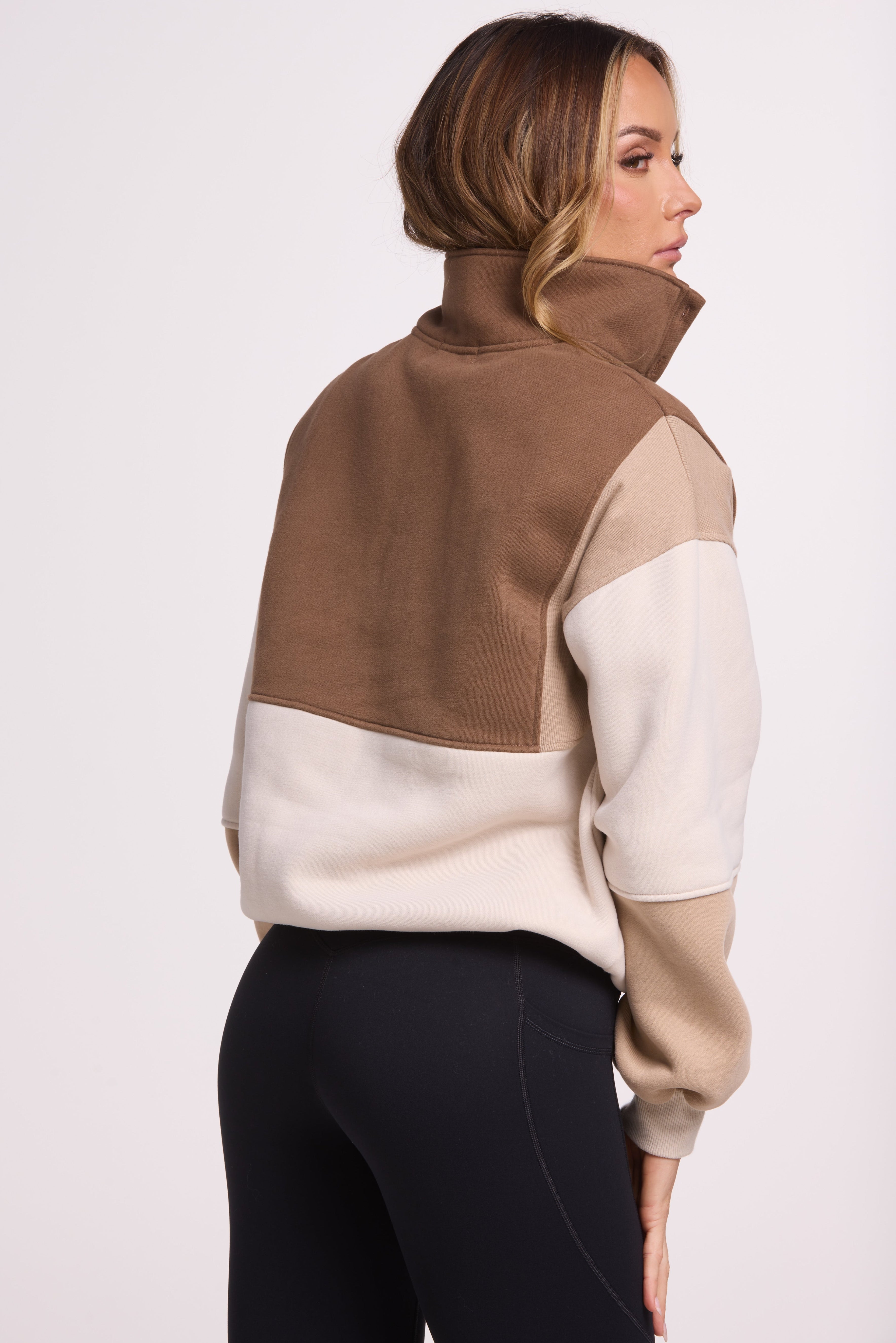 1/4 button up fleece jumper with earthy colour panels in chocolate and beige, with feature panels ribbed stretchy fabric inserts, and two convenient zip pockets.