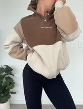Load image into Gallery viewer, 1/4 button up fleece jumper with earthy colour panels in chocolate and beige, with feature panels ribbed stretchy fabric inserts, and two convenient zip pockets.
