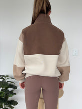 Load image into Gallery viewer, 1/4 button up fleece jumper with earthy colour panels in chocolate and beige, with feature panels ribbed stretchy fabric inserts, and two convenient zip pockets.

