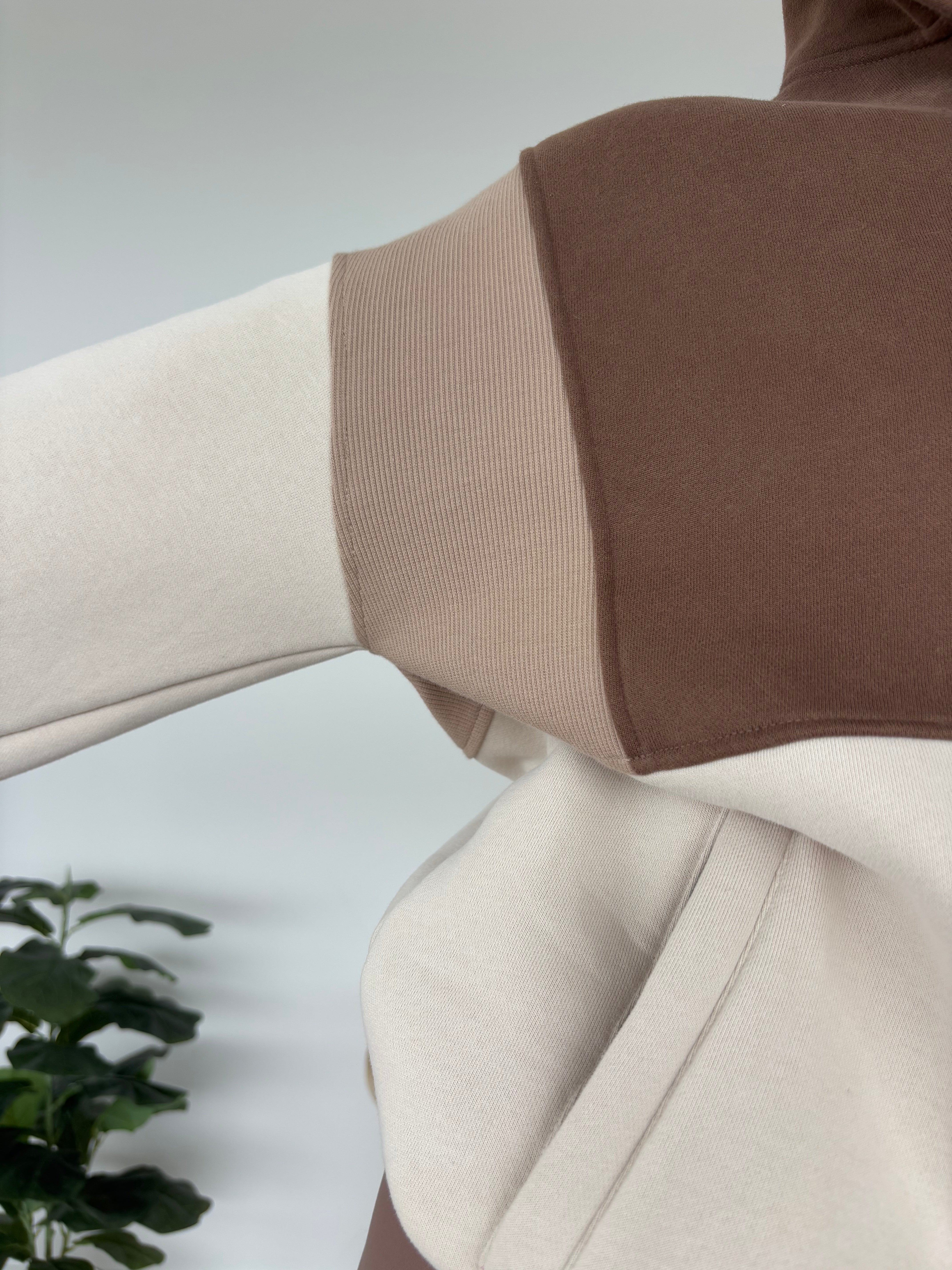 1/4 button up fleece jumper with earthy colour panels in chocolate and beige, with feature panels ribbed stretchy fabric inserts, and two convenient zip pockets.