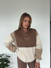 Load image into Gallery viewer, 1/4 button up fleece jumper with earthy colour panels in chocolate and beige, with feature panels ribbed stretchy fabric inserts, and two convenient zip pockets.
