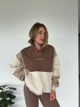 Load image into Gallery viewer, 1/4 button up fleece jumper with earthy colour panels in chocolate and beige, with feature panels ribbed stretchy fabric inserts, and two convenient zip pockets.
