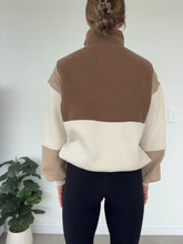 Load image into Gallery viewer, 1/4 button up fleece jumper with earthy colour panels in chocolate and beige, with feature panels ribbed stretchy fabric inserts, and two convenient zip pockets.
