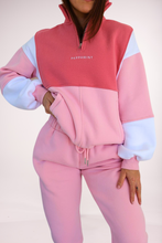 Load image into Gallery viewer, 1/4 zip fleece jumper with double collar, in peony pink/white and baby pink colour panels, with feature panels ribbed stretchy fabric inserts, and two convenient zip pockets paired with fleece lined joggers with elasticated waistband, drawstring and embossed logo icon on pocket
