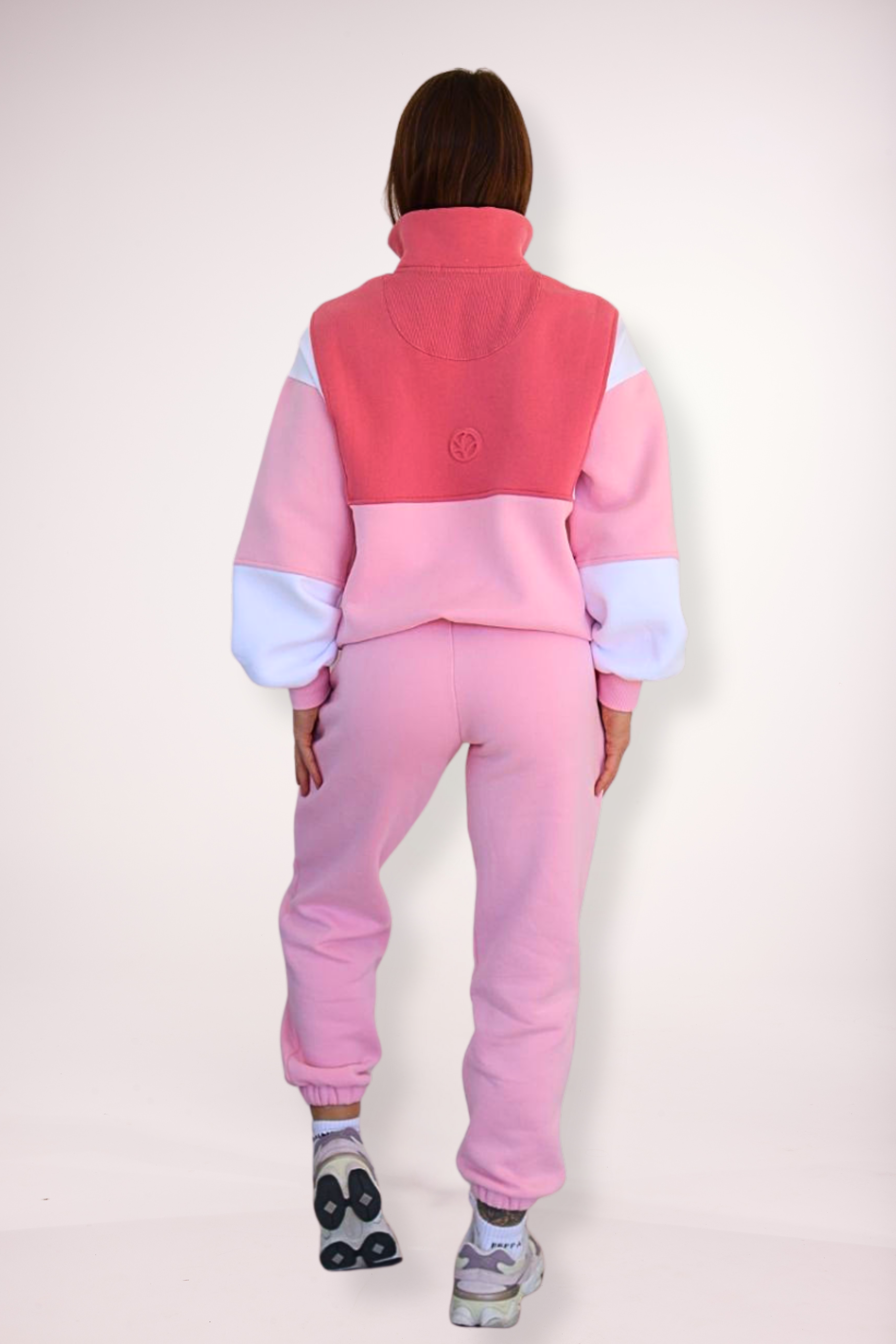 1/4 zip fleece jumper with double collar, in peony pink/white and baby pink colour panels, with feature panels ribbed stretchy fabric inserts, and two convenient zip pockets paired with fleece lined joggers with elasticated waistband, drawstring and embossed logo icon on pocket