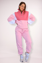 Load image into Gallery viewer, 1/4 zip fleece jumper with double collar, in peony pink/white and baby pink colour panels, with feature panels ribbed stretchy fabric inserts, and two convenient zip pockets paired with fleece lined joggers with elasticated waistband, drawstring and embossed logo icon on pocket
