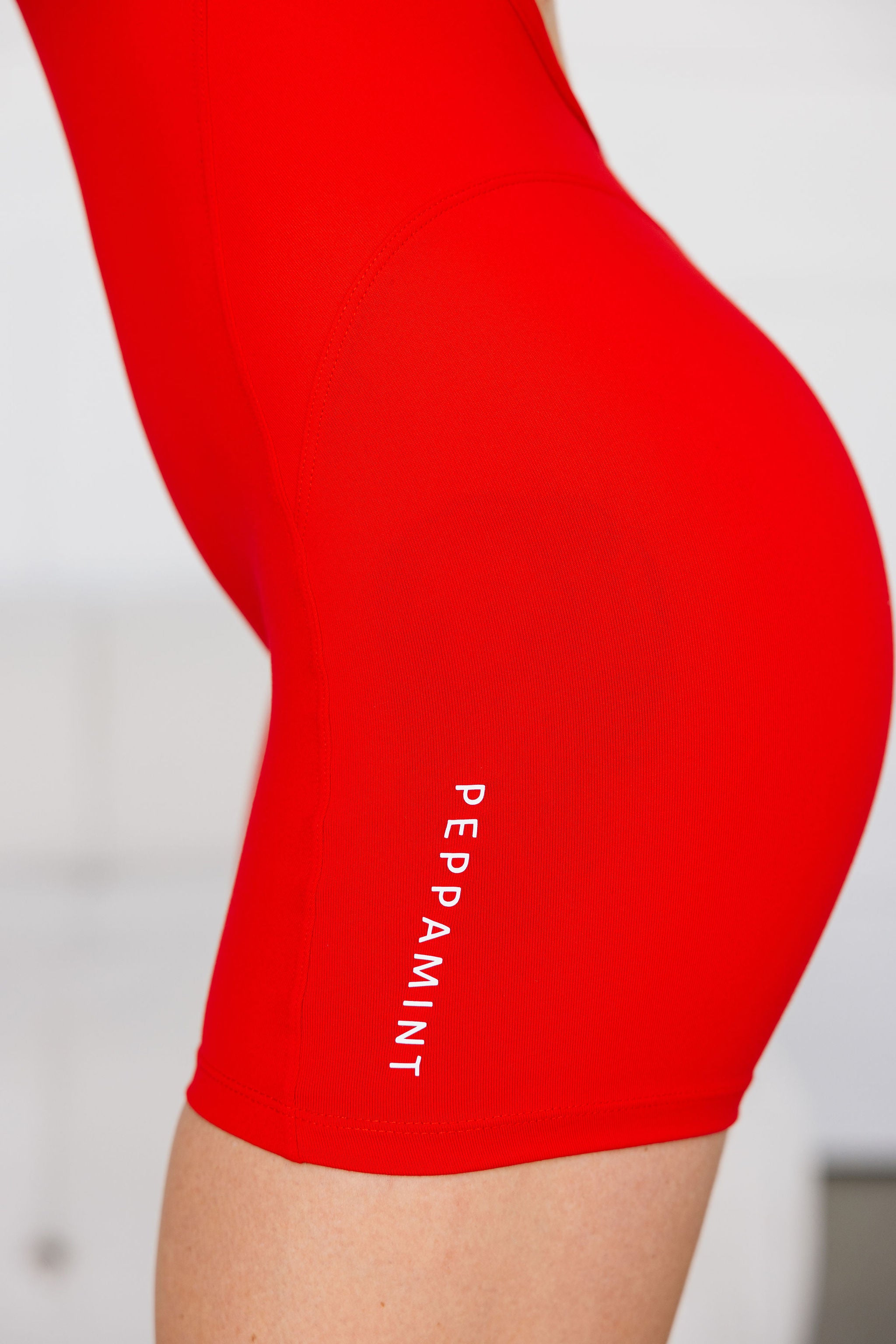 chilli red bodysuit with cross back straps, low back and sweetheart bum seams