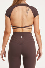 Load image into Gallery viewer, Buttery soft high waisted women&#39;s gym tights with curved hem stitched detailing for a butt shaping effect, and no front rise seam, paired with an open back women&#39;s crop t-shirt with a supportive elasticated hem and triple layered fabric with removable pads for extra support and aesthetic cross back straps in dark chocolate.
