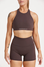 Load image into Gallery viewer, Buttery soft high waisted women&#39;s gym shorts with 4&quot; inseam with curved stitched detailing for a butt shaping effect, and no front rise seam, paired with a high neck women&#39;s sports bra with a supportive elasticated hem and triple layered fabric with removable pads for extra support and crossover back straps in Dark Chocolate.
