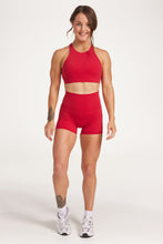 Load image into Gallery viewer, Buttery soft high waisted women&#39;s gym shorts with 4&quot; inseam with curved stitched detailing for a butt shaping effect, and no front rise seam, paired with a high neck women&#39;s sports bra with a supportive elasticated hem and triple layered fabric with removable pads for extra support and crossover back straps in Raspberry red.
