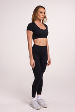 Load image into Gallery viewer, Buttery soft high waisted women&#39;s gym tights with practical pockets, sweetheart back seams for an upper glute shaping effect, and no front rise seam, paired with an V neck women&#39;s crop t-shirt with a supportive elasticated hem and triple layered fabric with removable pads for extra support in black
