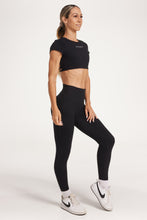 Load image into Gallery viewer, Buttery soft high waisted women&#39;s gym tights with curved hem stitched detailing for a butt shaping effect, and no front rise seam, paired with an open back women&#39;s crop t-shirt with a supportive elasticated hem and triple layered fabric with removable pads for extra support and aesthetic cross back straps in Black.
