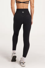 Load image into Gallery viewer, Buttery soft high waisted women&#39;s gym tights with curved hem stitched detailing for a butt shaping effect, and no front rise seam in Black.
