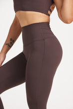 Load image into Gallery viewer, Buttery soft high waisted women&#39;s gym tights with curved hem stitched detailing for a butt shaping effect, and no front rise seam, paired with an open back women&#39;s crop t-shirt with a supportive elasticated hem and triple layered fabric with removable pads for extra support and aesthetic cross back straps in dark chocolate.
