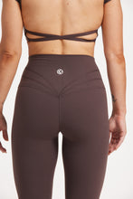 Load image into Gallery viewer, Buttery soft high waisted women&#39;s gym tights with curved hem stitched detailing for a butt shaping effect, and no front rise seam, paired with an open back women&#39;s crop t-shirt with a supportive elasticated hem and triple layered fabric with removable pads for extra support and aesthetic cross back straps in dark chocolate.
