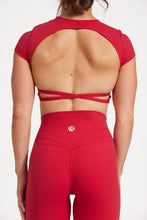 Load image into Gallery viewer, Buttery soft high waisted women&#39;s gym tights with curved hem stitched detailing for a butt shaping effect, and no front rise seam, paired with an open back women&#39;s crop t-shirt with a supportive elasticated hem and triple layered fabric with removable pads for extra support and aesthetic cross back straps in Raspberry red.
