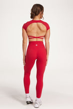 Load image into Gallery viewer, Buttery soft high waisted women&#39;s gym tights with curved hem stitched detailing for a butt shaping effect, and no front rise seam, paired with an open back women&#39;s crop t-shirt with a supportive elasticated hem and triple layered fabric with removable pads for extra support and aesthetic cross back straps in Raspberry red.
