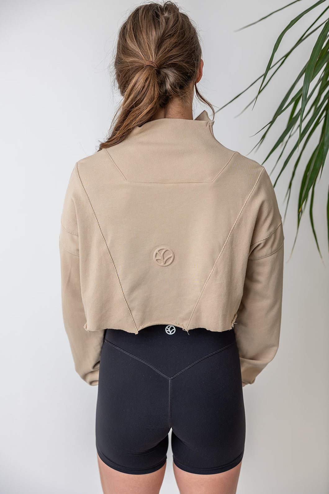 french terry cotton crop jacket with ribbed panels, raw edge hem and iconic embossed logo with half zip