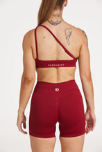 Load image into Gallery viewer, Cross over strap activewear bra in seamless fabric with adjustable back straps, and ribbed supportive underbust band in wine red
