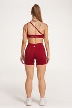 Load image into Gallery viewer, Cross over strap activewear bra in seamless fabric with adjustable back straps, and ribbed supportive underbust band in wine red
