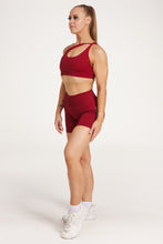 Load image into Gallery viewer, Cross over strap activewear bra in seamless fabric with adjustable back straps, and ribbed supportive underbust band in wine red
