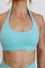 Load image into Gallery viewer, seamless halter bra with a thick supportive fabric blend and a branded back strap in mint green
