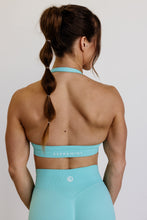 Load image into Gallery viewer, seamless halter bra with a thick supportive fabric blend and a branded back strap in mint green
