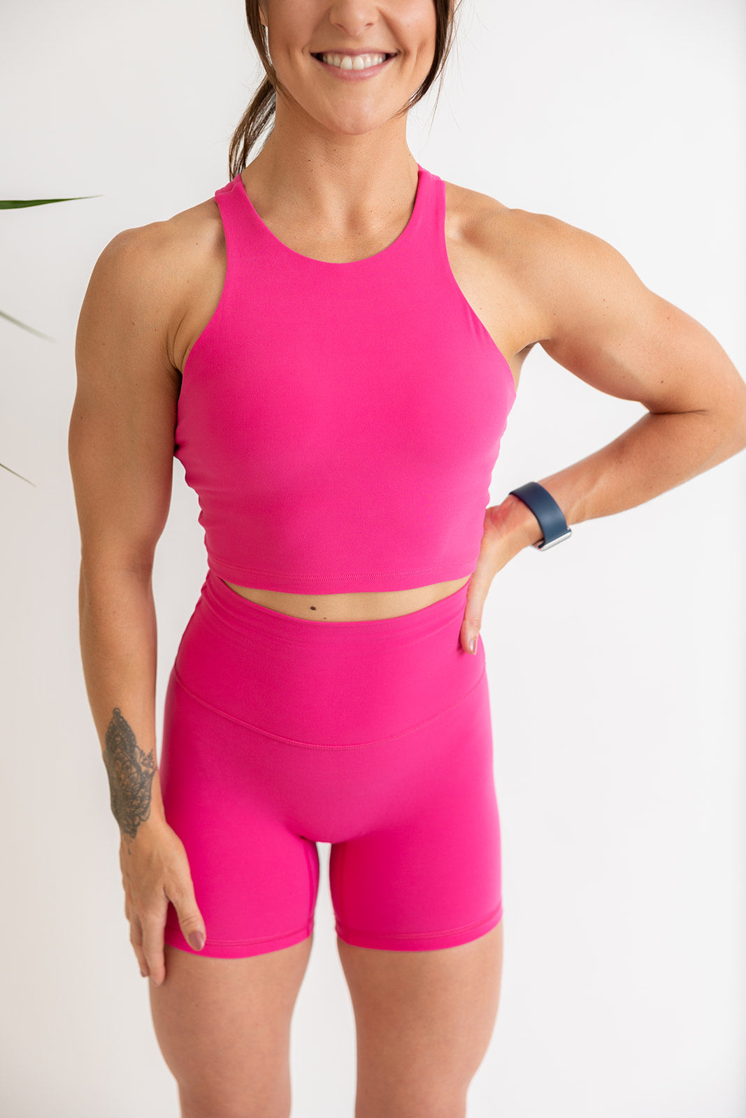 crop tank top in hot pink with build in removable bra pads, racerback design and subtle stitched logo tag