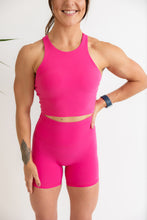 Load image into Gallery viewer, crop tank top in hot pink with build in removable bra pads, racerback design and subtle stitched logo tag
