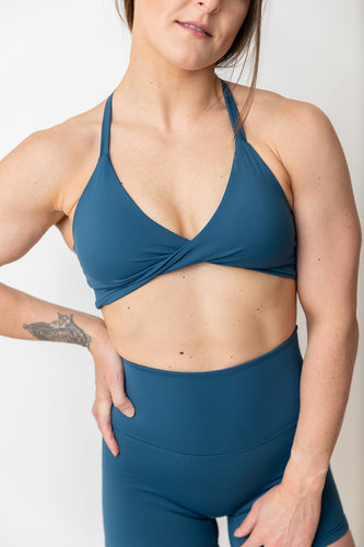 prussian blue twist front sports bra with triangle shape strap strap back