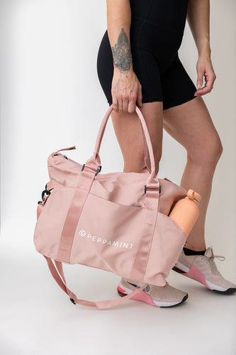 Carry all gym back in pink with convenient carry handles + cross body handle attachment