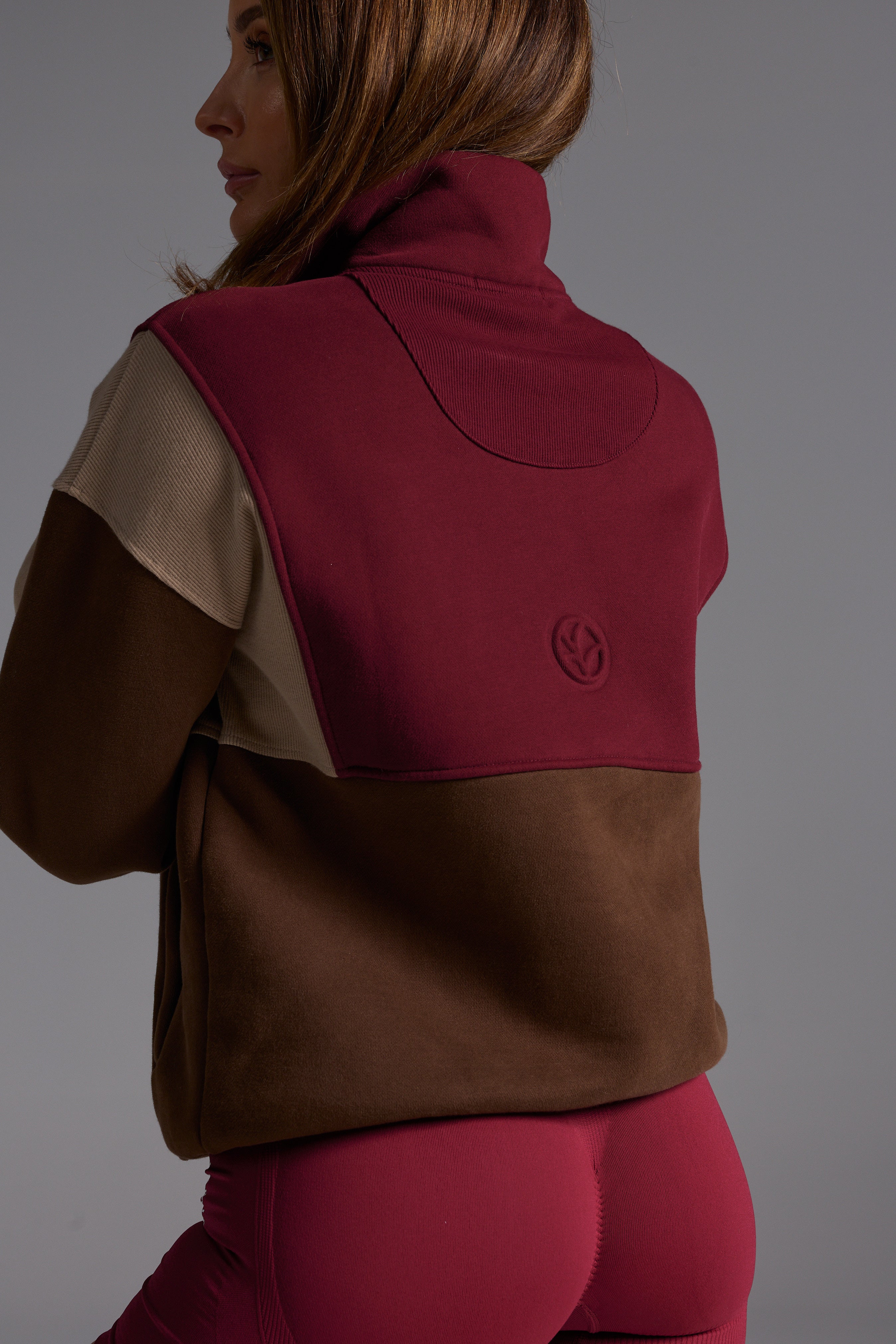 1/4 zip fleece jumper with double collar, ribbed stretchy fabric panel inserts, and two convenient zip pockets in a wine, chocolate and beige colour block design.