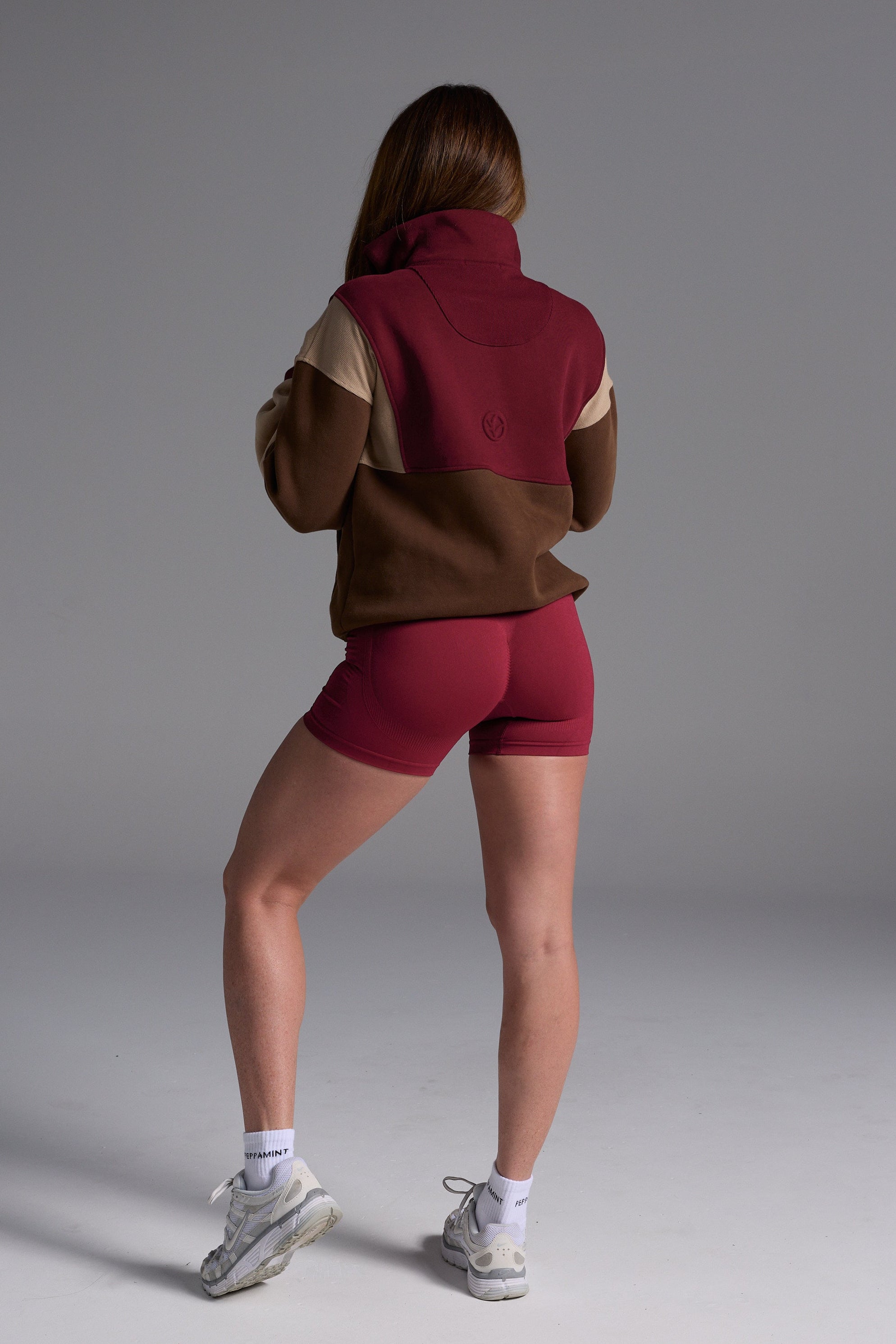 1/4 zip fleece jumper with double collar, ribbed stretchy fabric panel inserts, and two convenient zip pockets in a wine, chocolate and beige colour block design.