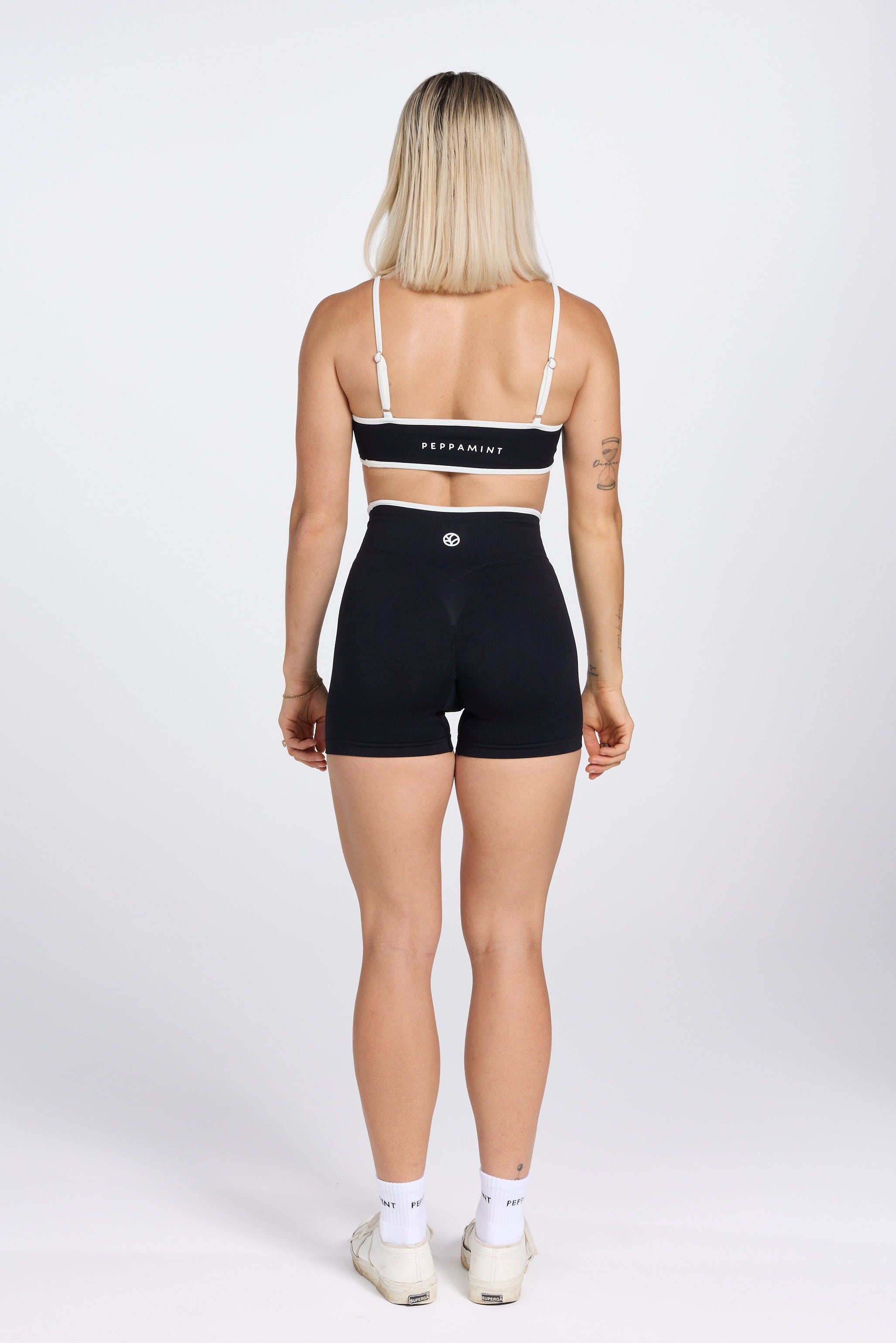 Seamless gym bra, with luxe white trim and adjustable back straps in black colour.