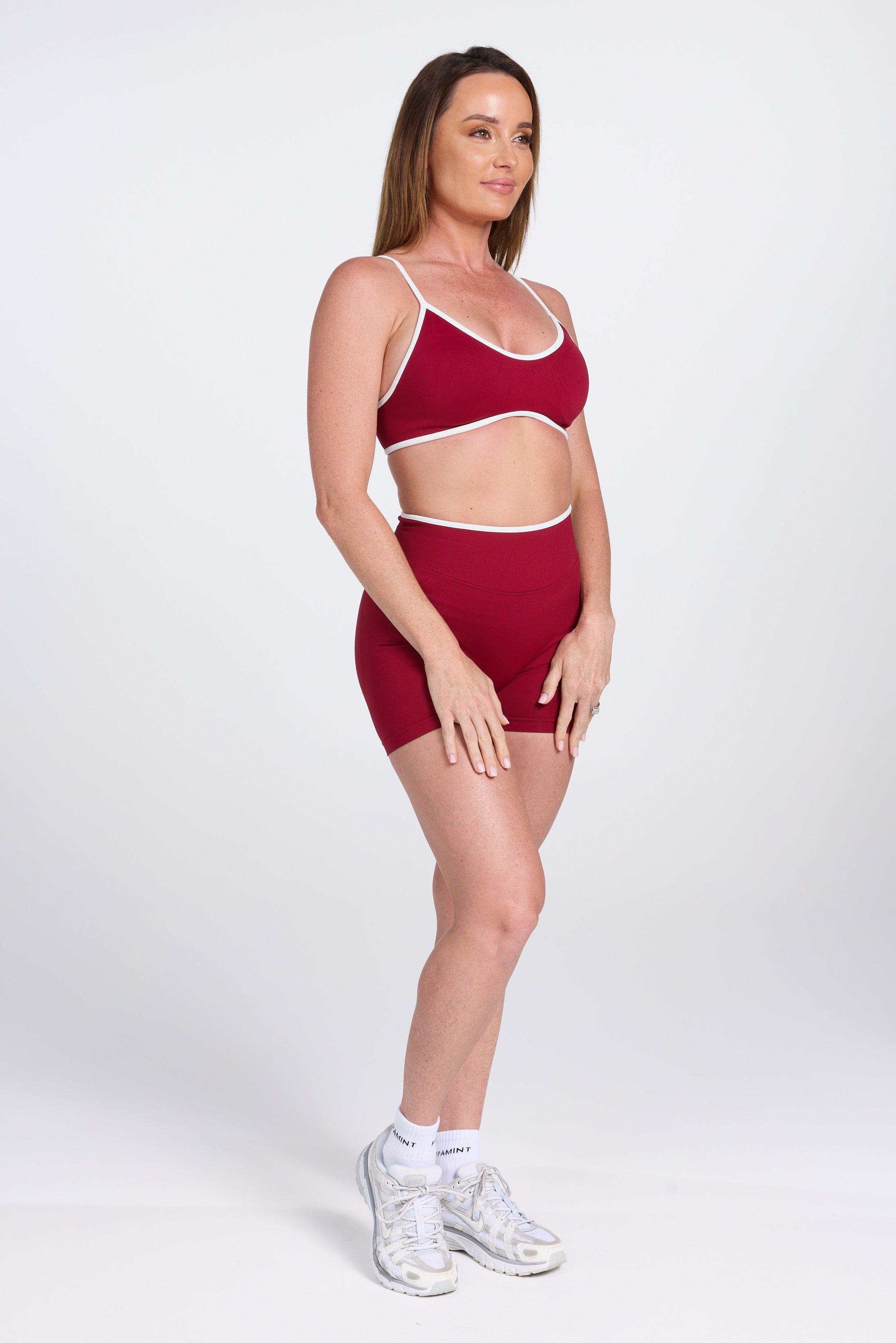 Seamless gym bra, with luxe white trim and adjustable back straps in wine colour.