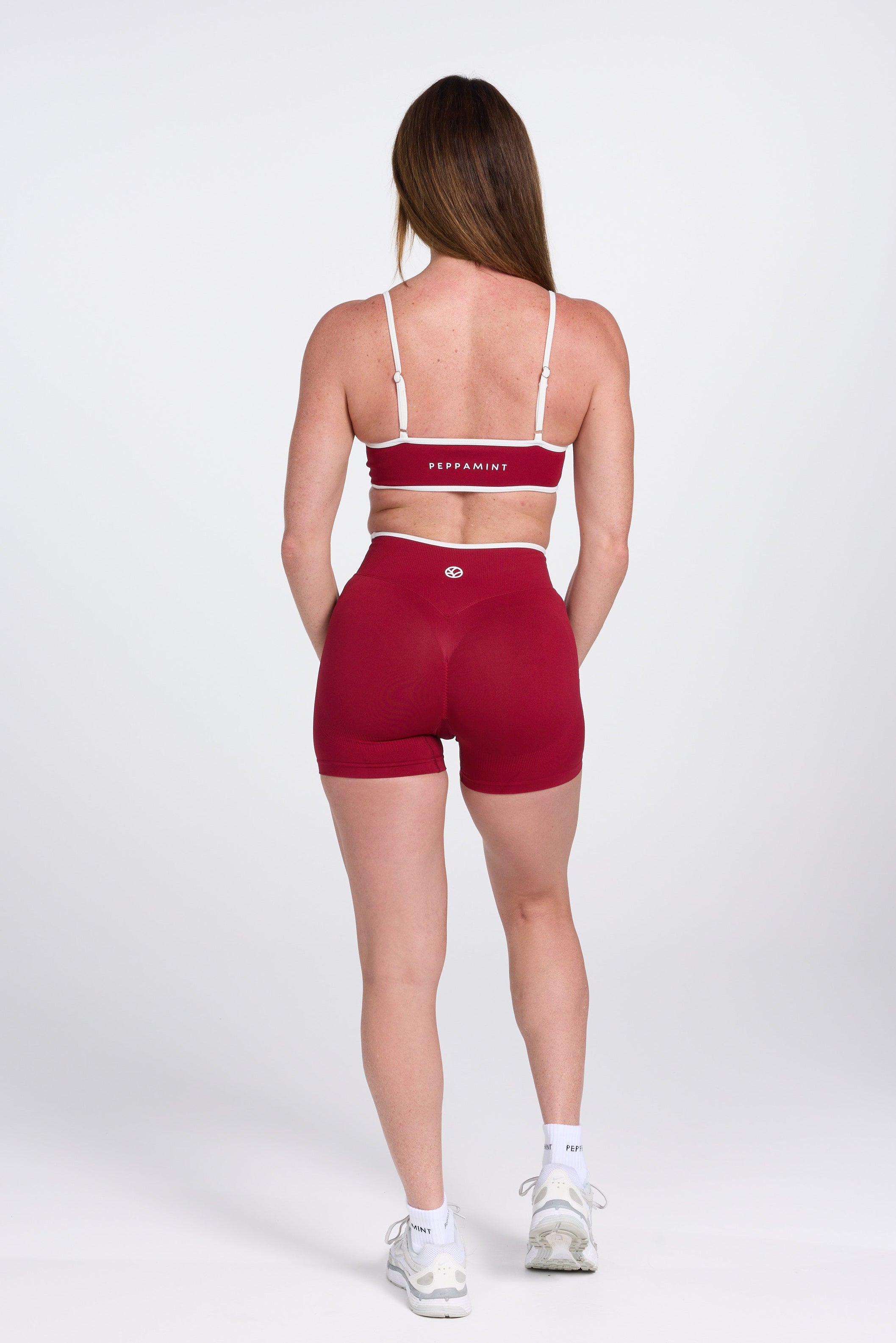 Seamless gym bra, with luxe white trim and adjustable back straps in wine colour.